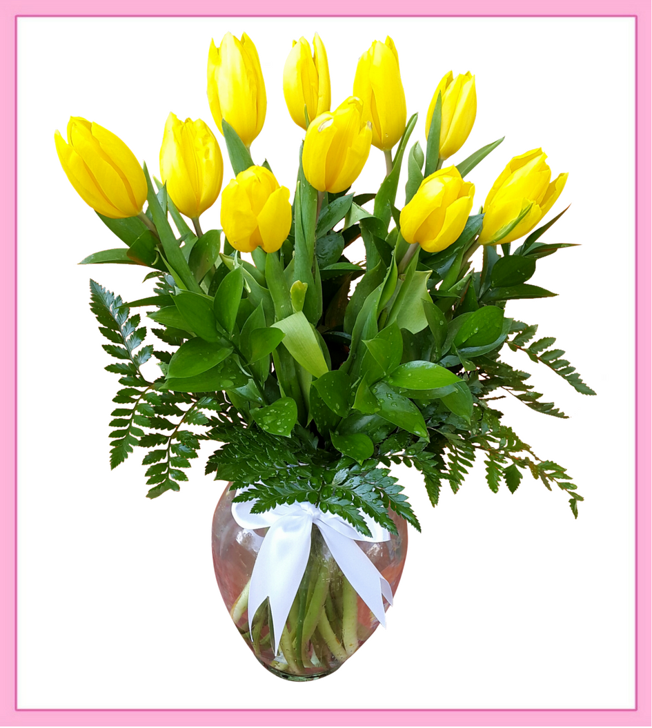 Arreglo de Tulipanes Holandeses con 10 piezas, follajes finos colocadas en un florero de cristal fino adornado con un moño de listón. Las flores están listas en nuestra florería las 24 horas.